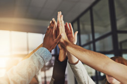 Shot of a group of colleagues giving each other a high five